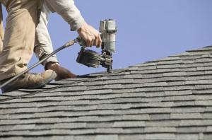 nail gun used on roof by worker